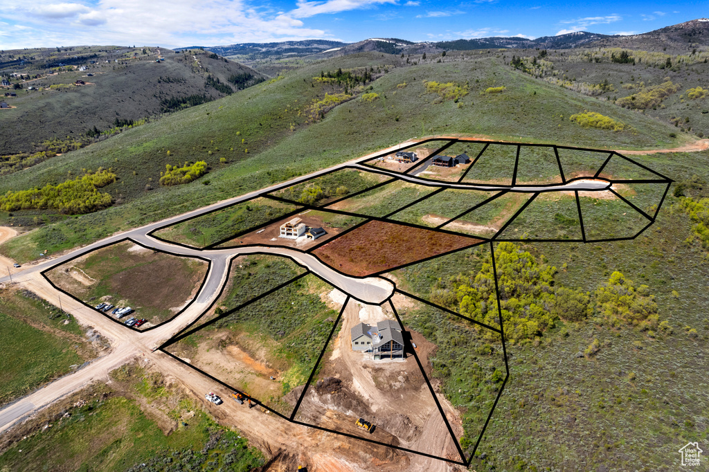 Aerial view of property and surrounding area with property boundaries highlighted and mountains