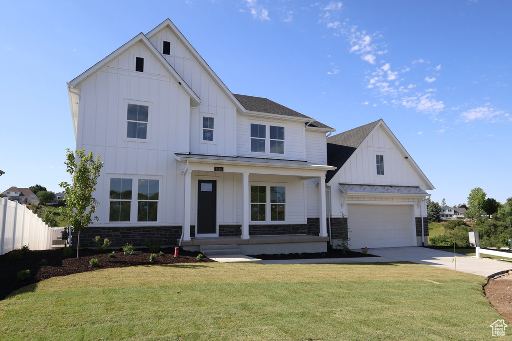 Modern inspired farmhouse with board and batten siding, a porch, concrete driveway, and a garage
