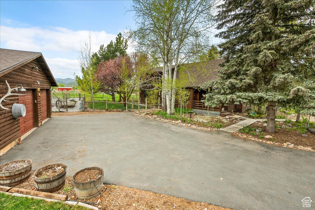View of patio featuring fence and an outbuilding