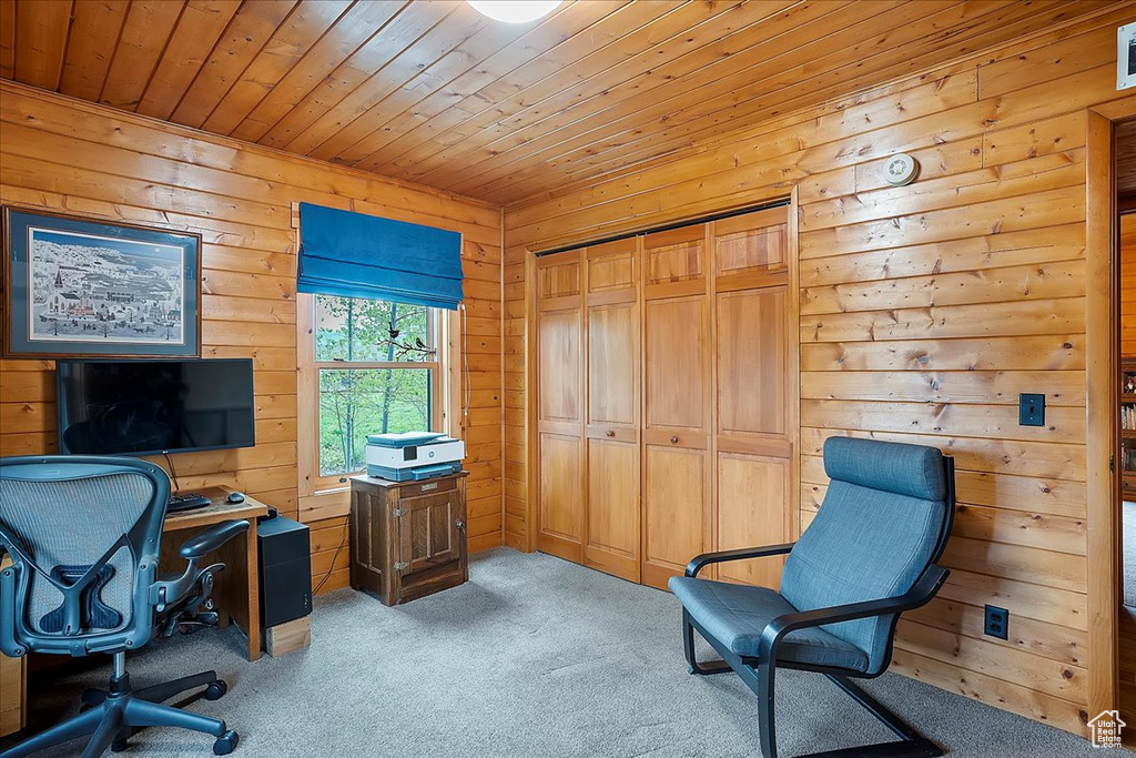 Home office featuring carpet floors, wooden ceiling, and wood walls