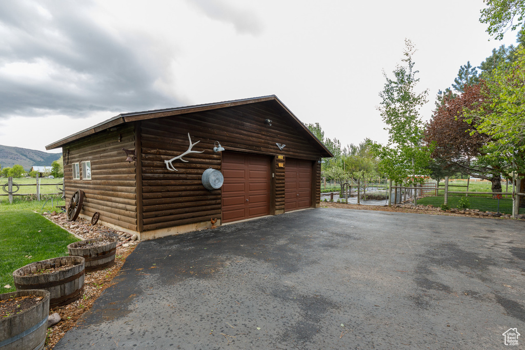 Garage with fence and a mountain view