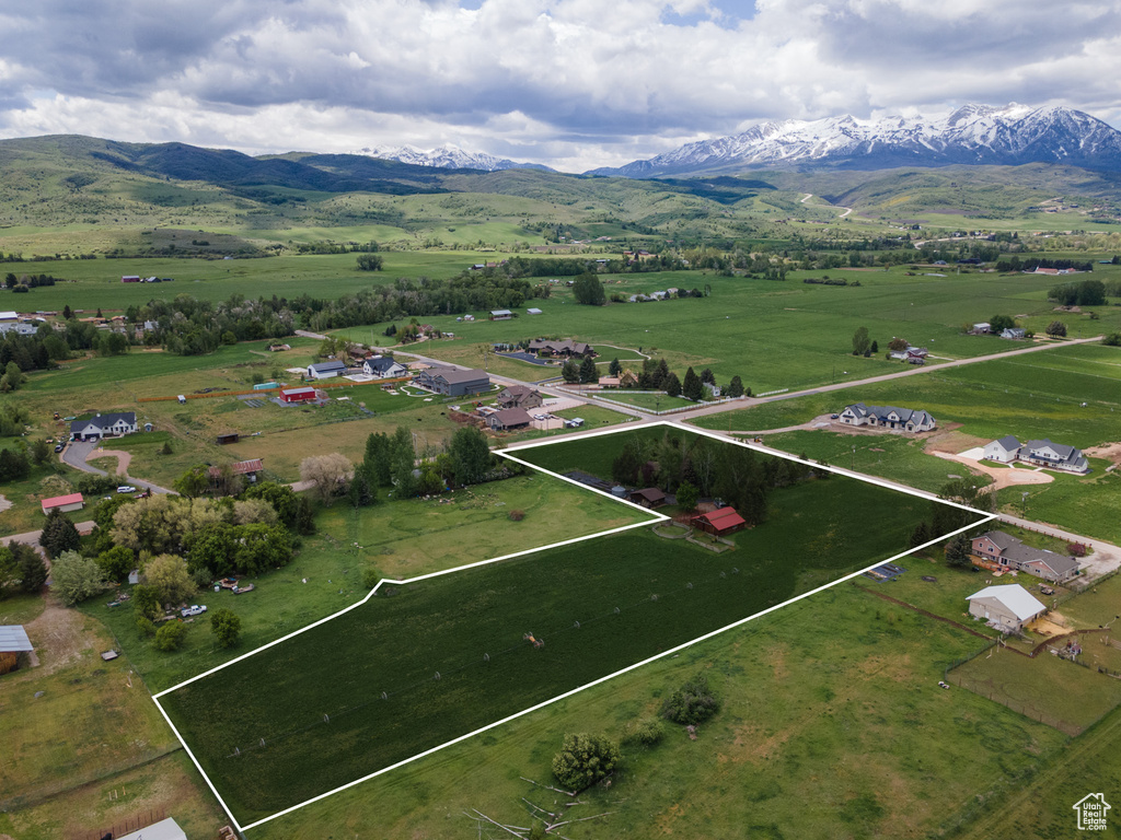 Aerial view of sparsely populated area featuring property boundaries highlighted and mountains