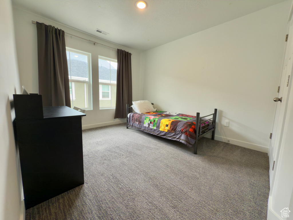Carpeted bedroom with baseboards