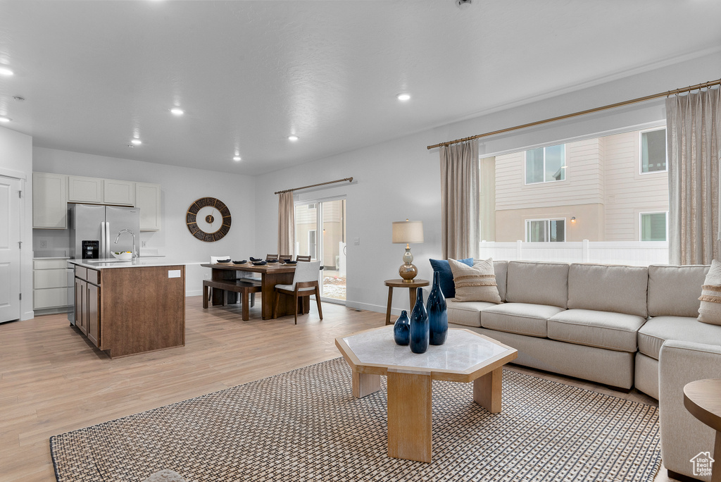 Living room featuring recessed lighting, light wood-style flooring, and baseboards