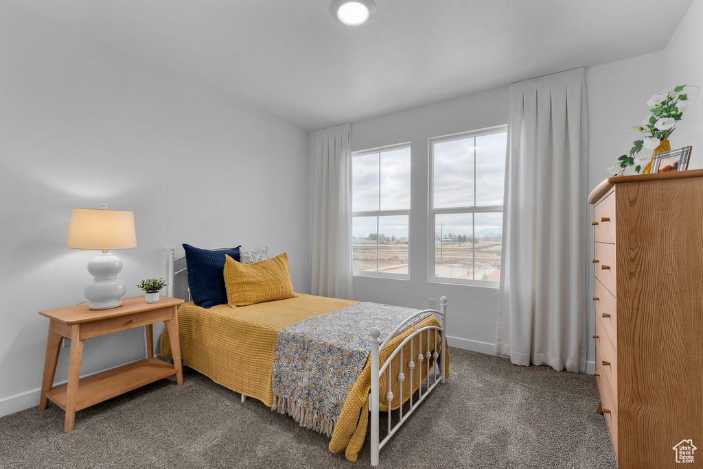 Carpeted bedroom featuring baseboards
