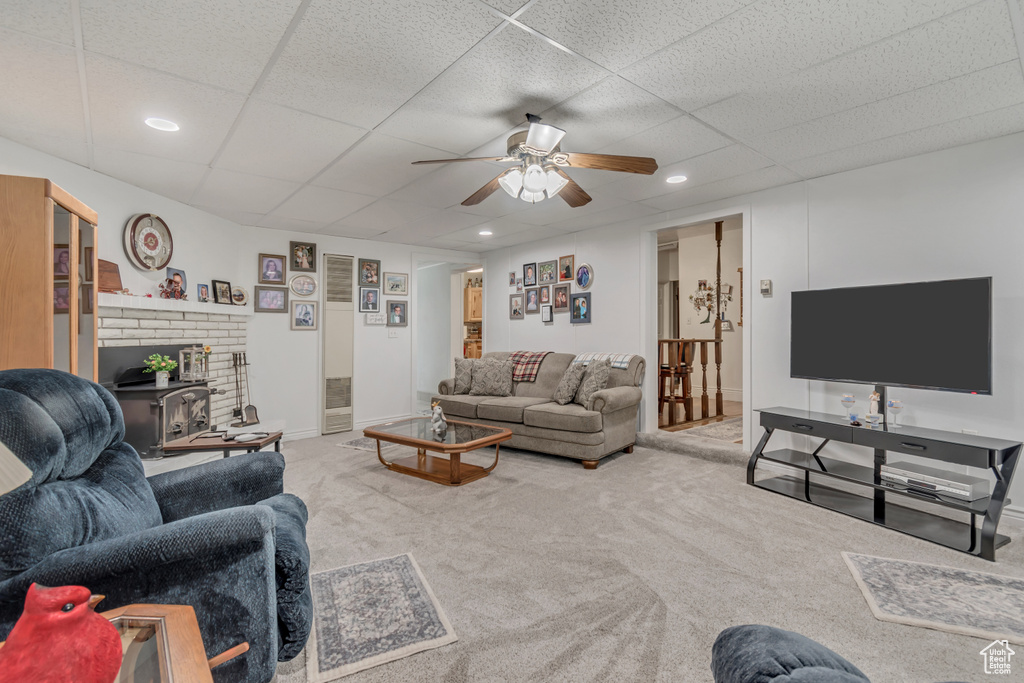 Living area featuring a ceiling fan, carpet floors, a paneled ceiling, recessed lighting, and baseboards