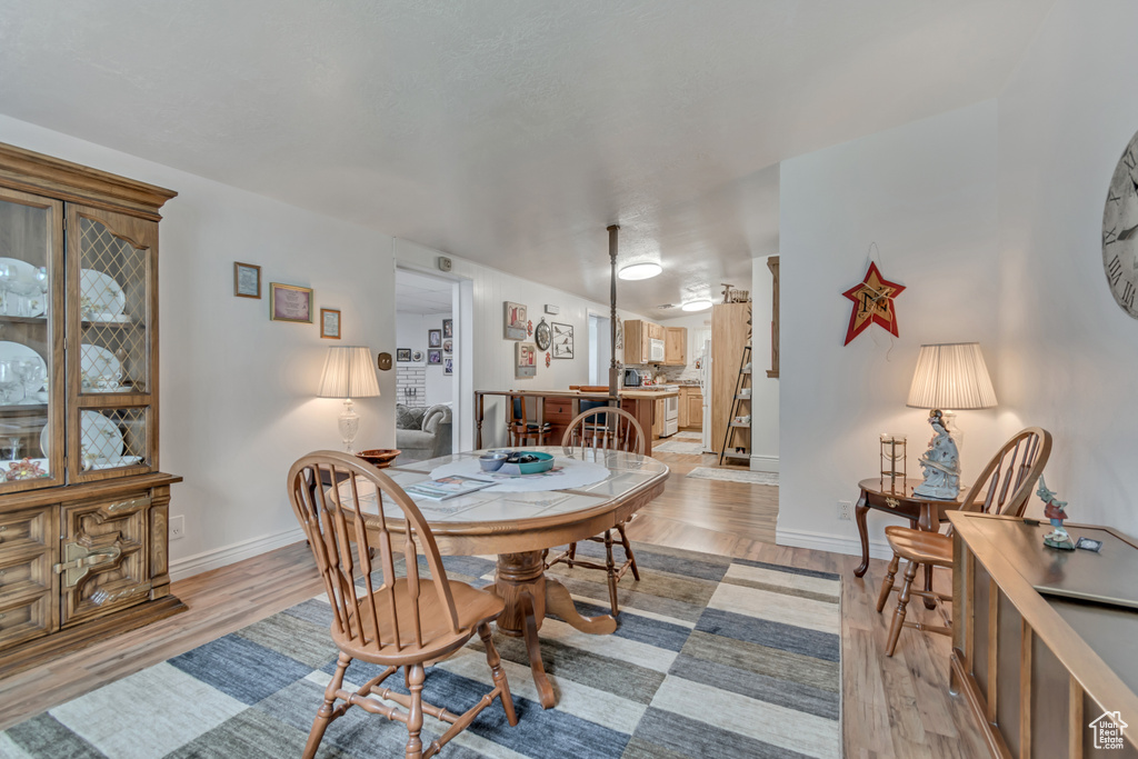 Dining room with baseboards and light wood-type flooring