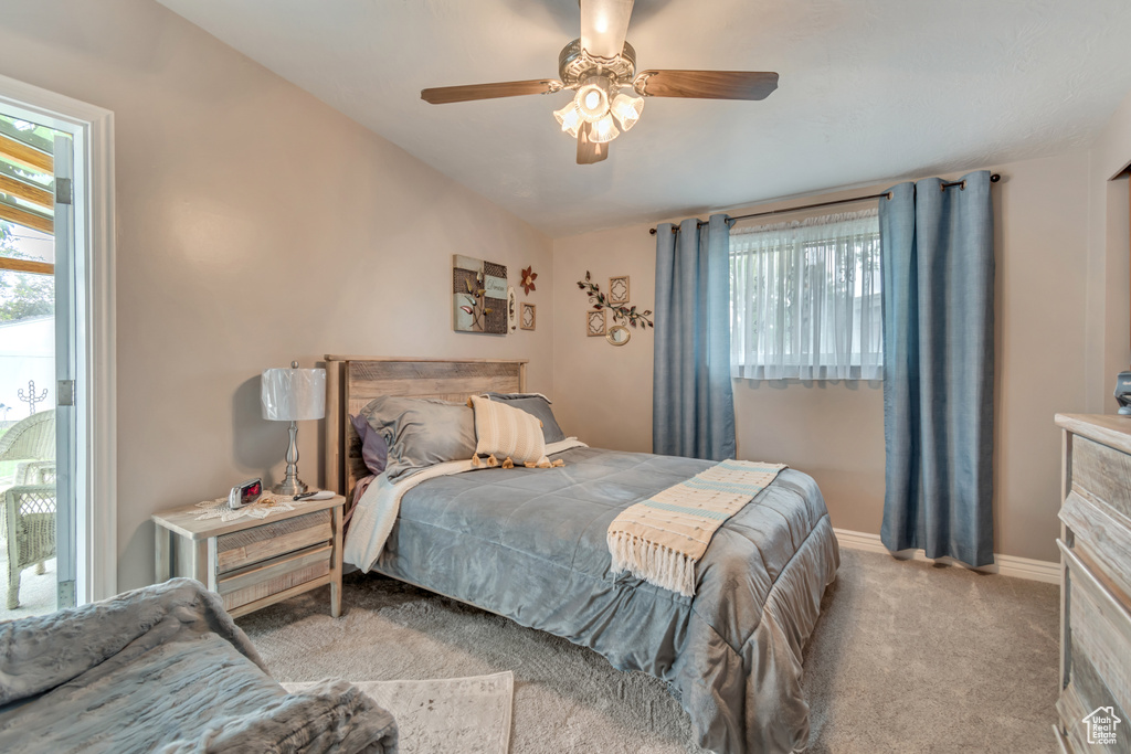 Carpeted bedroom with baseboards and ceiling fan