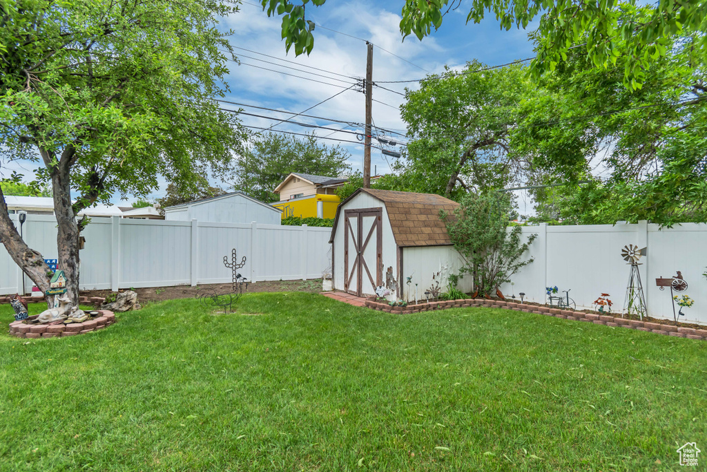 View of yard with a storage unit and an outbuilding