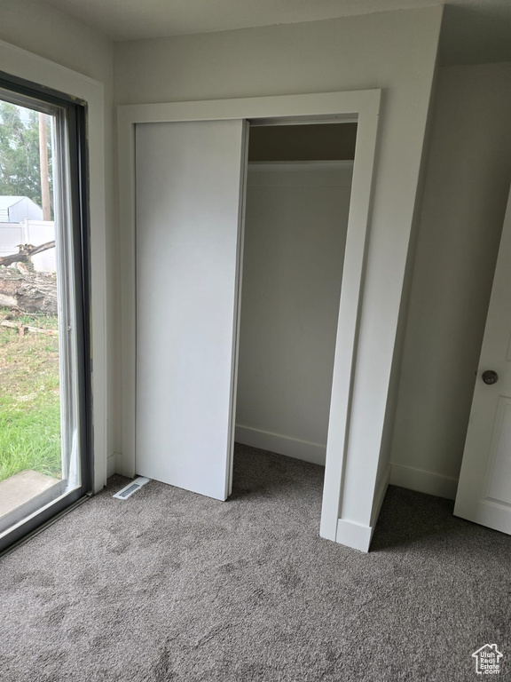 Unfurnished bedroom with carpet floors and a closet