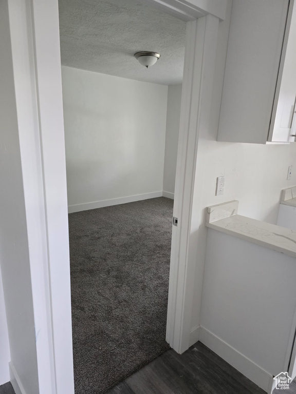 Bathroom featuring baseboards and a textured ceiling