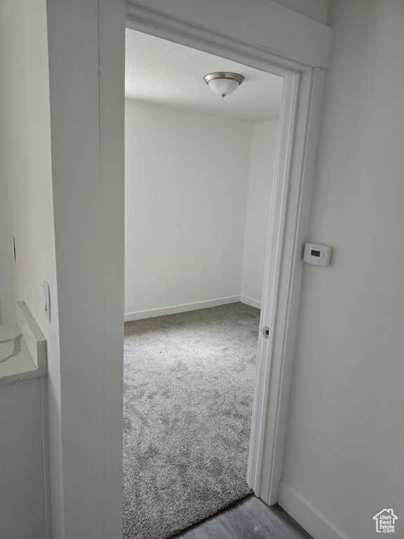 Carpeted empty room featuring baseboards