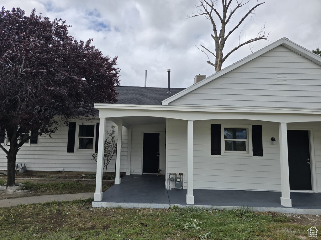 Bungalow featuring covered porch and a shingled roof