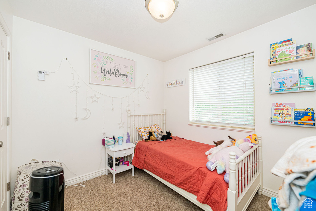 Bedroom with carpet floors and baseboards