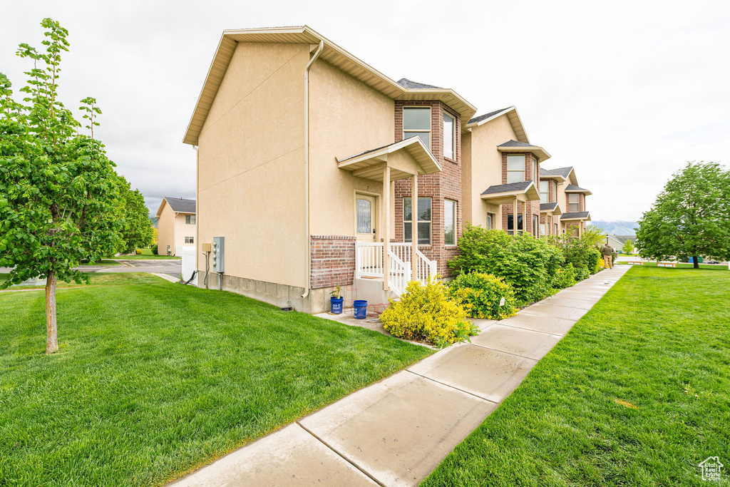 View of home's exterior with a lawn and stucco siding