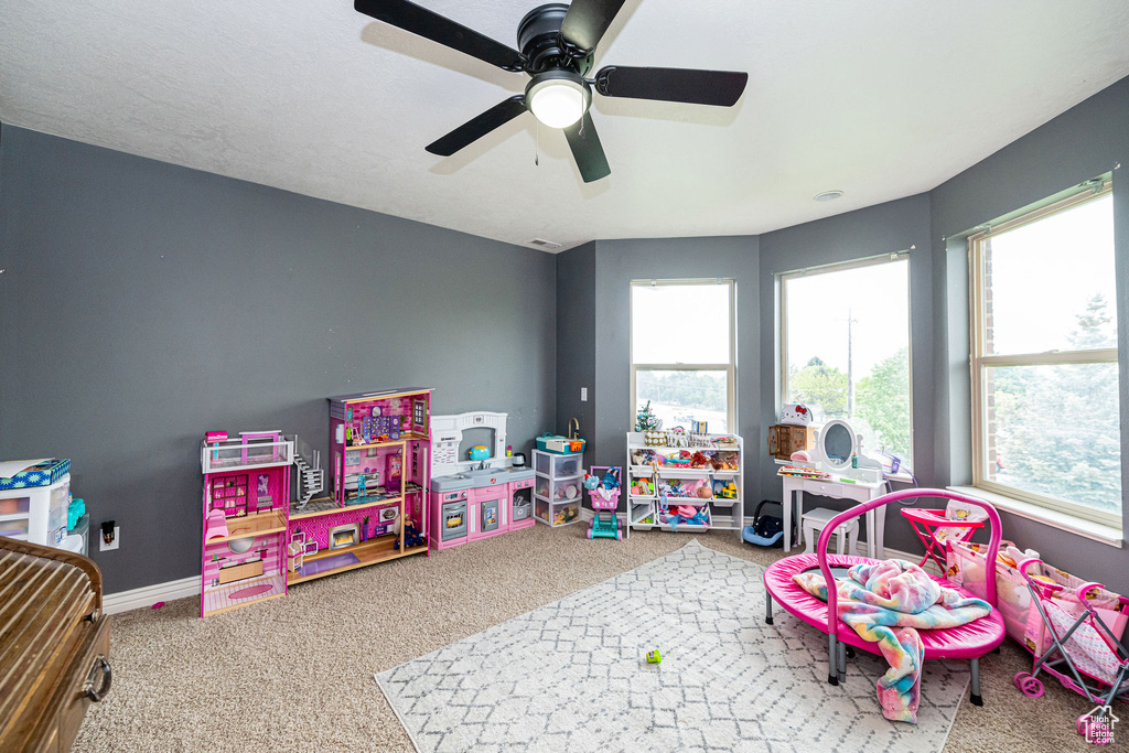 Playroom with plenty of natural light, carpet flooring, ceiling fan, and baseboards