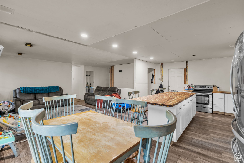 Dining space with recessed lighting and wood finished floors