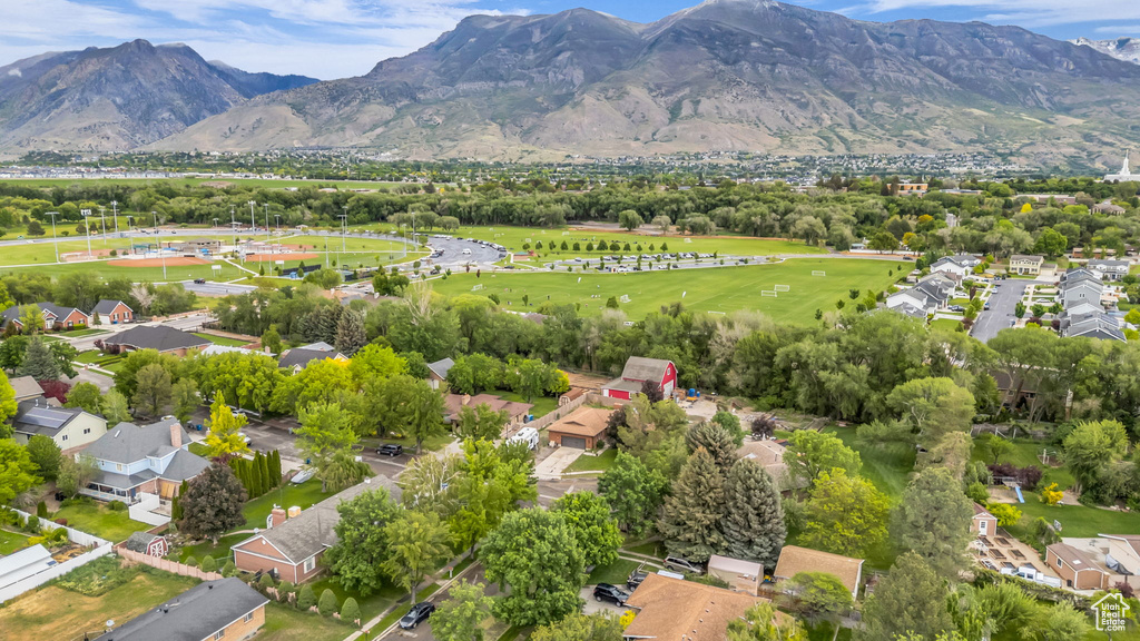Aerial view of property's location featuring a mountainous background and nearby suburban area