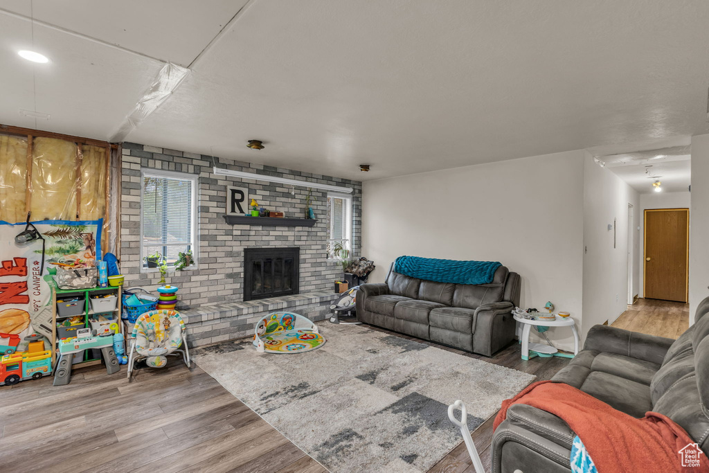 Living area with wood finished floors and a fireplace