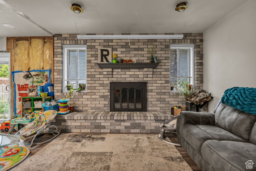 Living area with a fireplace and brick wall