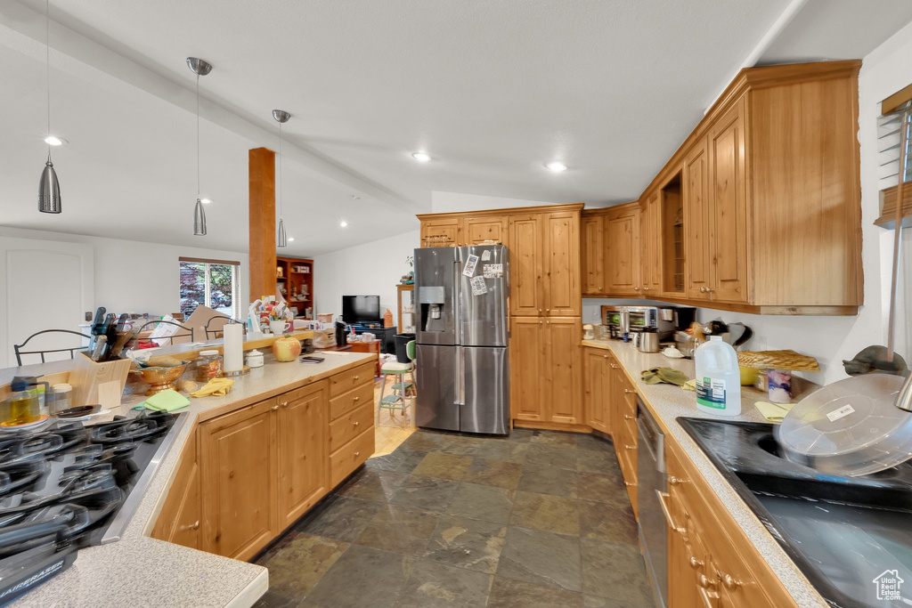 Kitchen with stainless steel appliances, lofted ceiling, stone finish flooring, light countertops, and recessed lighting