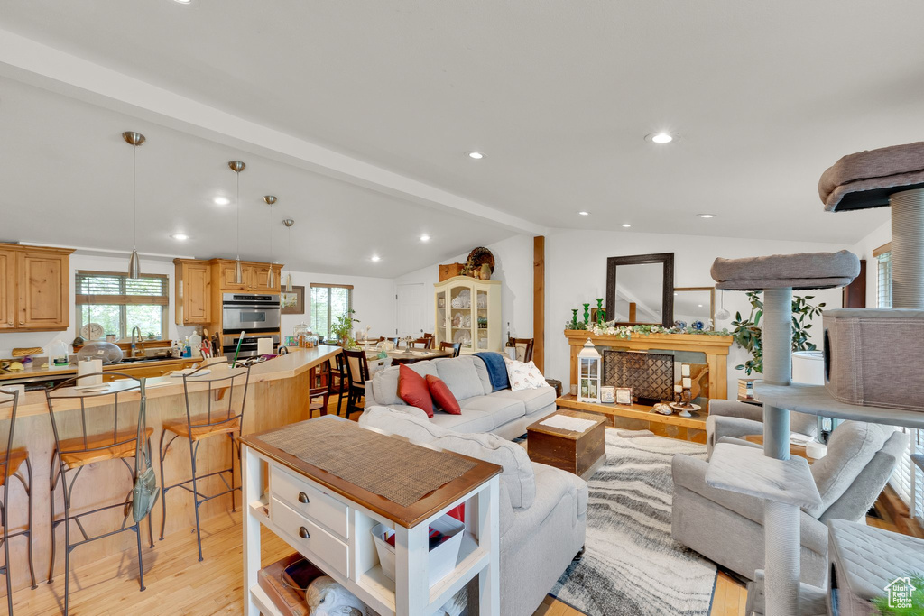 Living area with light wood-style flooring, recessed lighting, and a fireplace