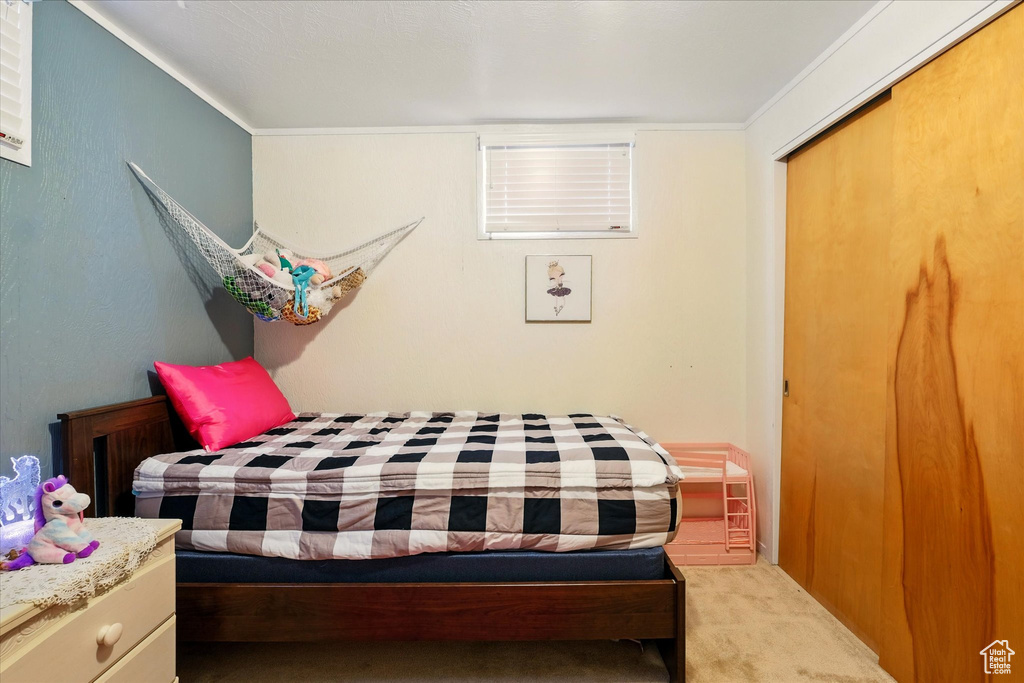 Bedroom with carpet floors and crown molding