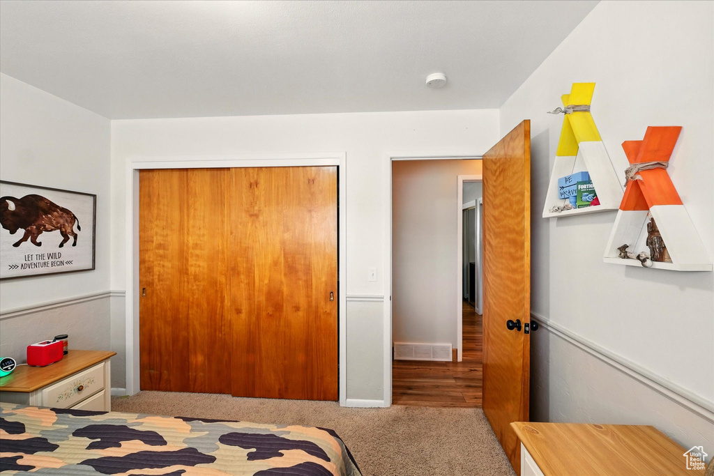 Bedroom with carpet and a closet