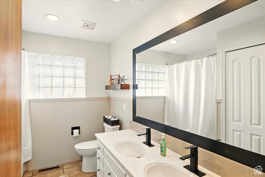 Full bathroom with toilet, tile patterned flooring, double vanity, and recessed lighting