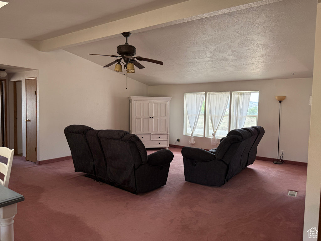 Carpeted living room with baseboards and ceiling fan