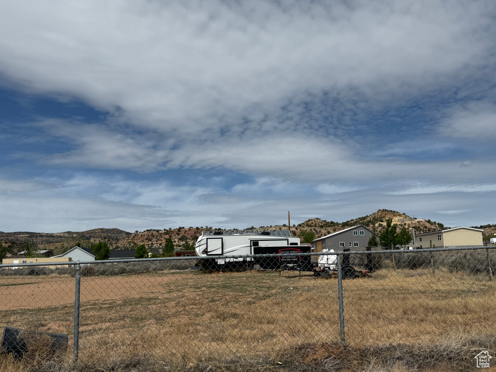 View of yard featuring fence and a mountain view