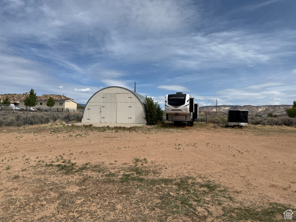 View of yard featuring an outdoor structure and a pole building