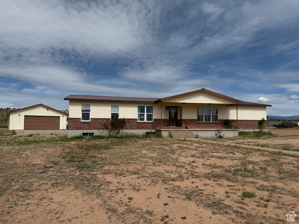 View of front of property with brick siding and an outdoor structure