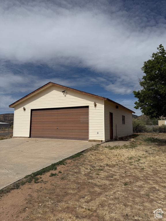 Detached garage featuring fence
