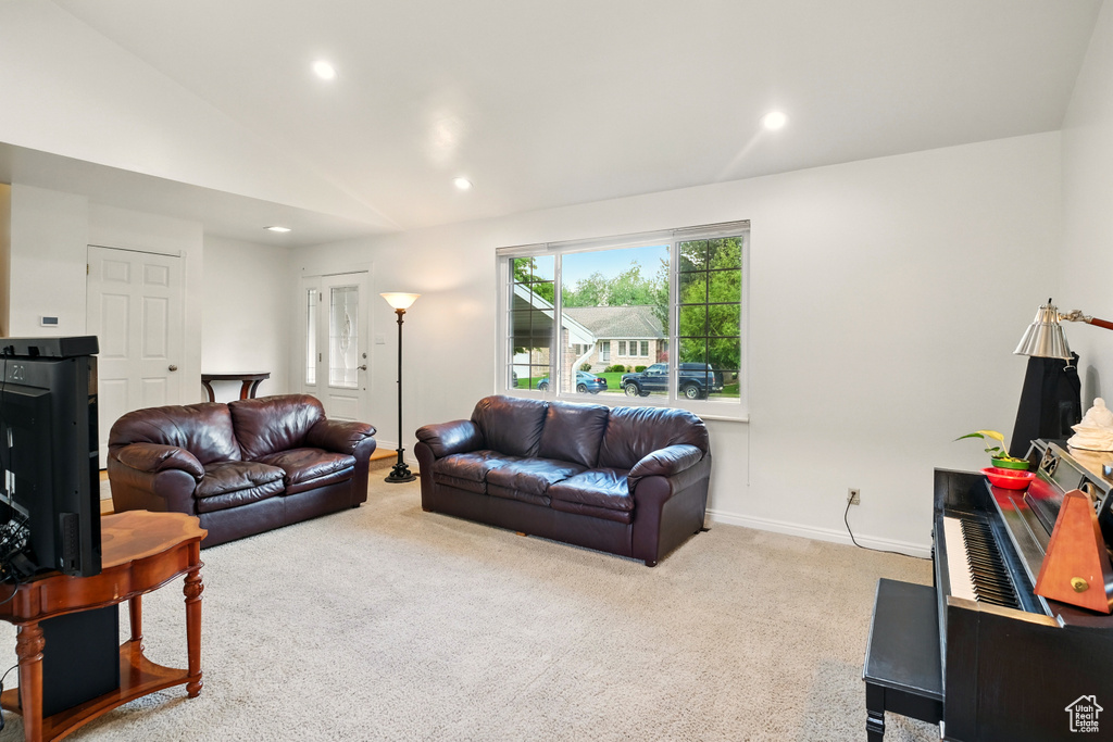 Living area featuring carpet flooring, recessed lighting, baseboards, and lofted ceiling