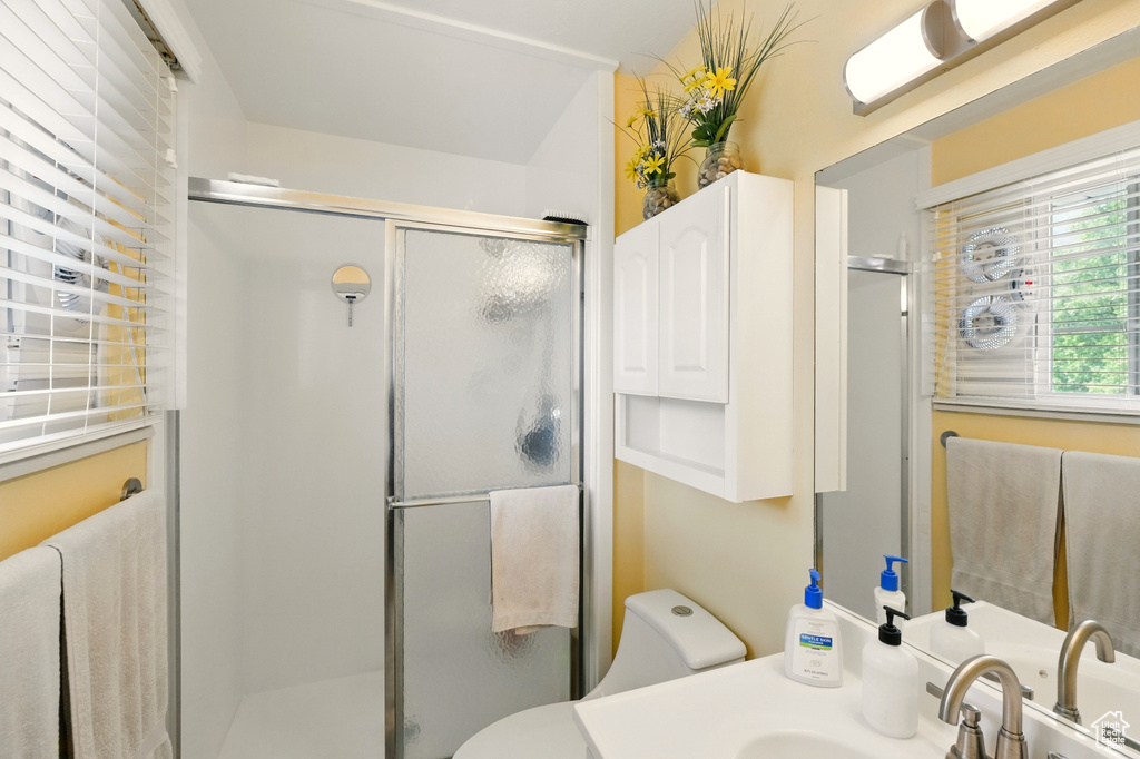 Full bath with a shower stall, toilet, and vanity