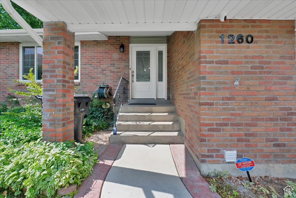 View of exterior entry with brick siding