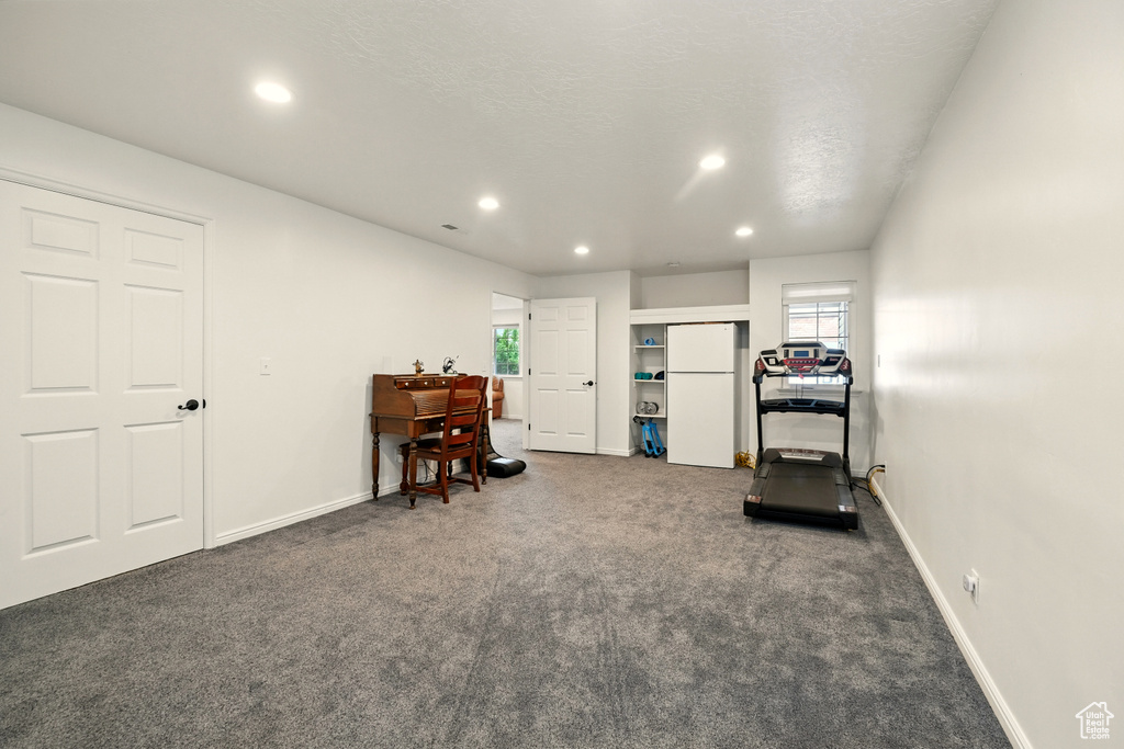 Workout area featuring dark carpet, recessed lighting, and baseboards