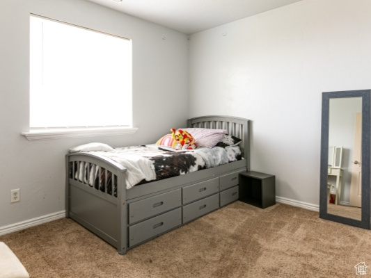 Carpeted bedroom with baseboards