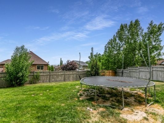 View of yard featuring a trampoline