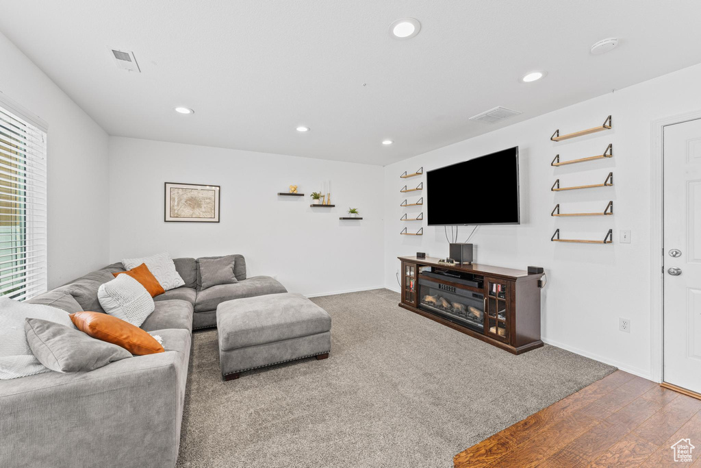 Living room featuring recessed lighting, wood finished floors, and baseboards