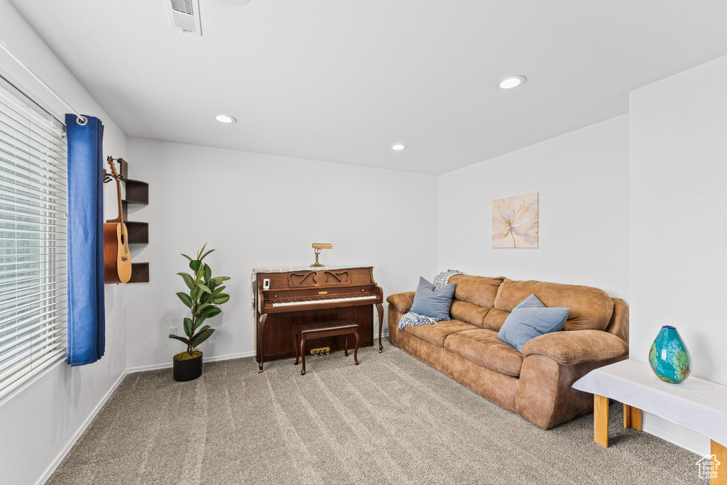 Living area featuring carpet floors, recessed lighting, and baseboards