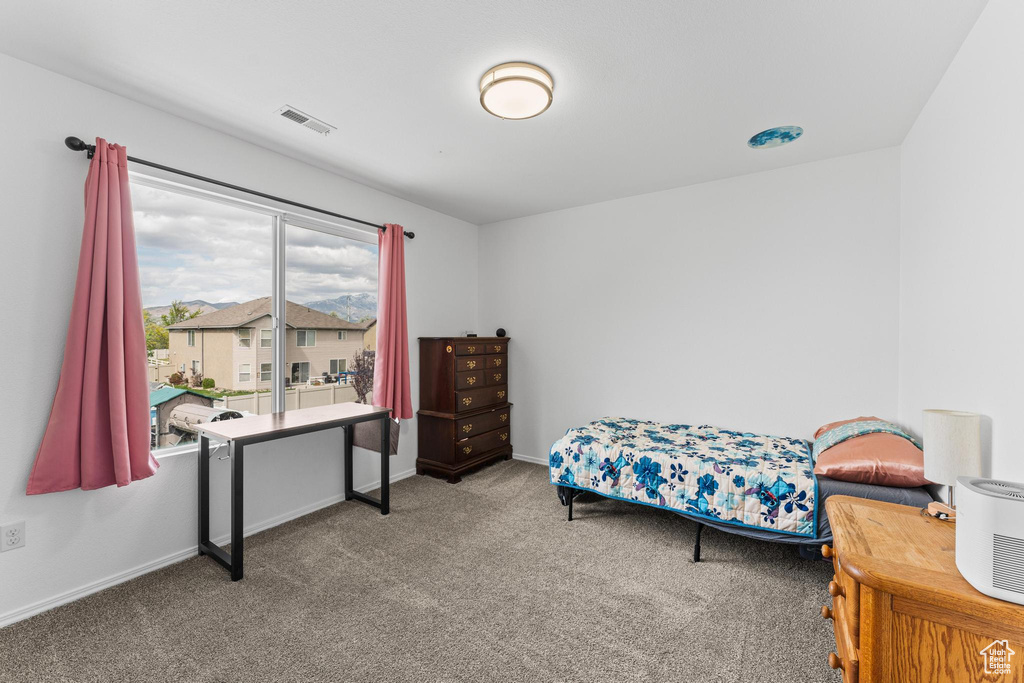 Carpeted bedroom with baseboards