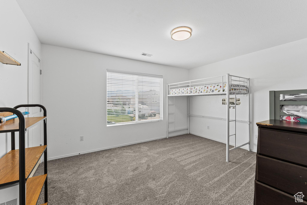 Unfurnished bedroom featuring carpet flooring and baseboards