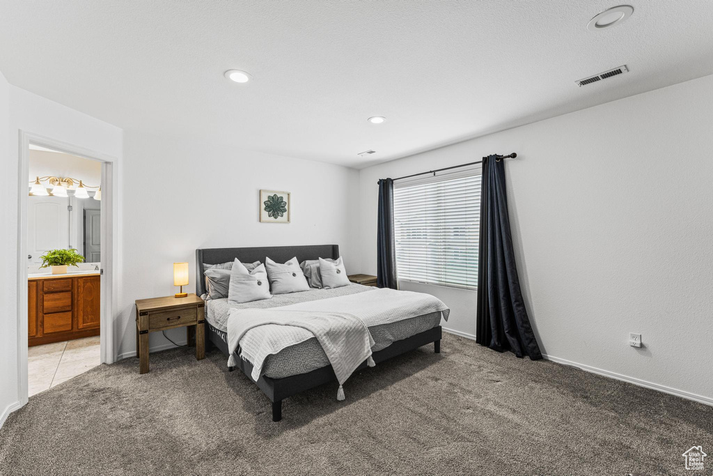 Bedroom with light carpet, ensuite bath, recessed lighting, and baseboards