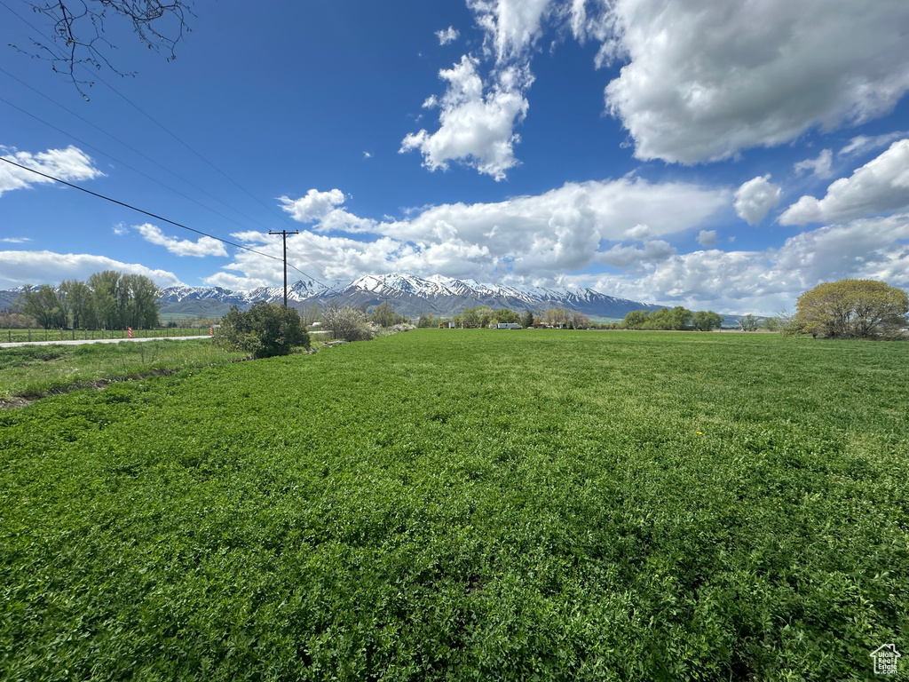 View of green lawn featuring a view of countryside and a mountain view