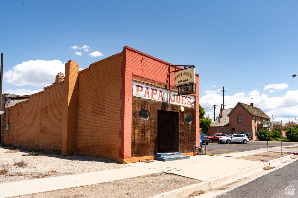View of building exterior featuring uncovered parking