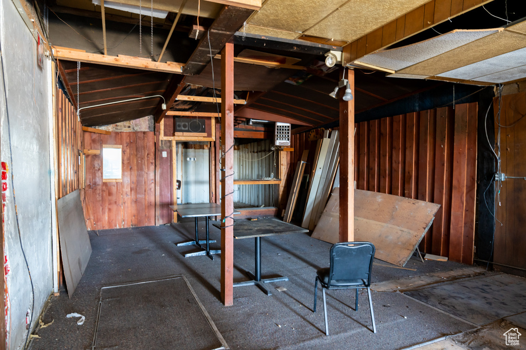 Miscellaneous room featuring wooden walls and vaulted ceiling