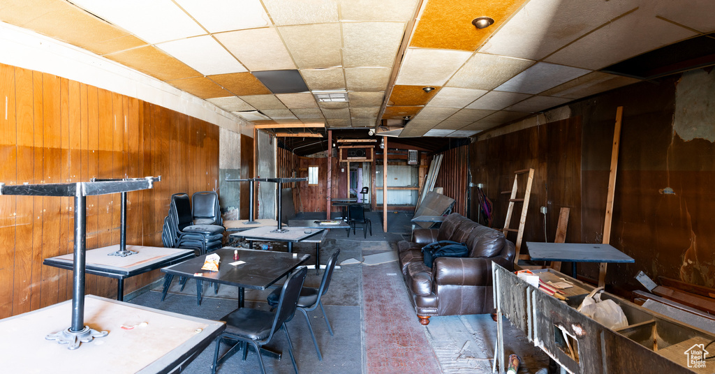 Living area with wood walls and concrete flooring
