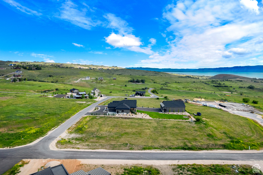 Aerial view of sparsely populated area featuring a water and mountain view